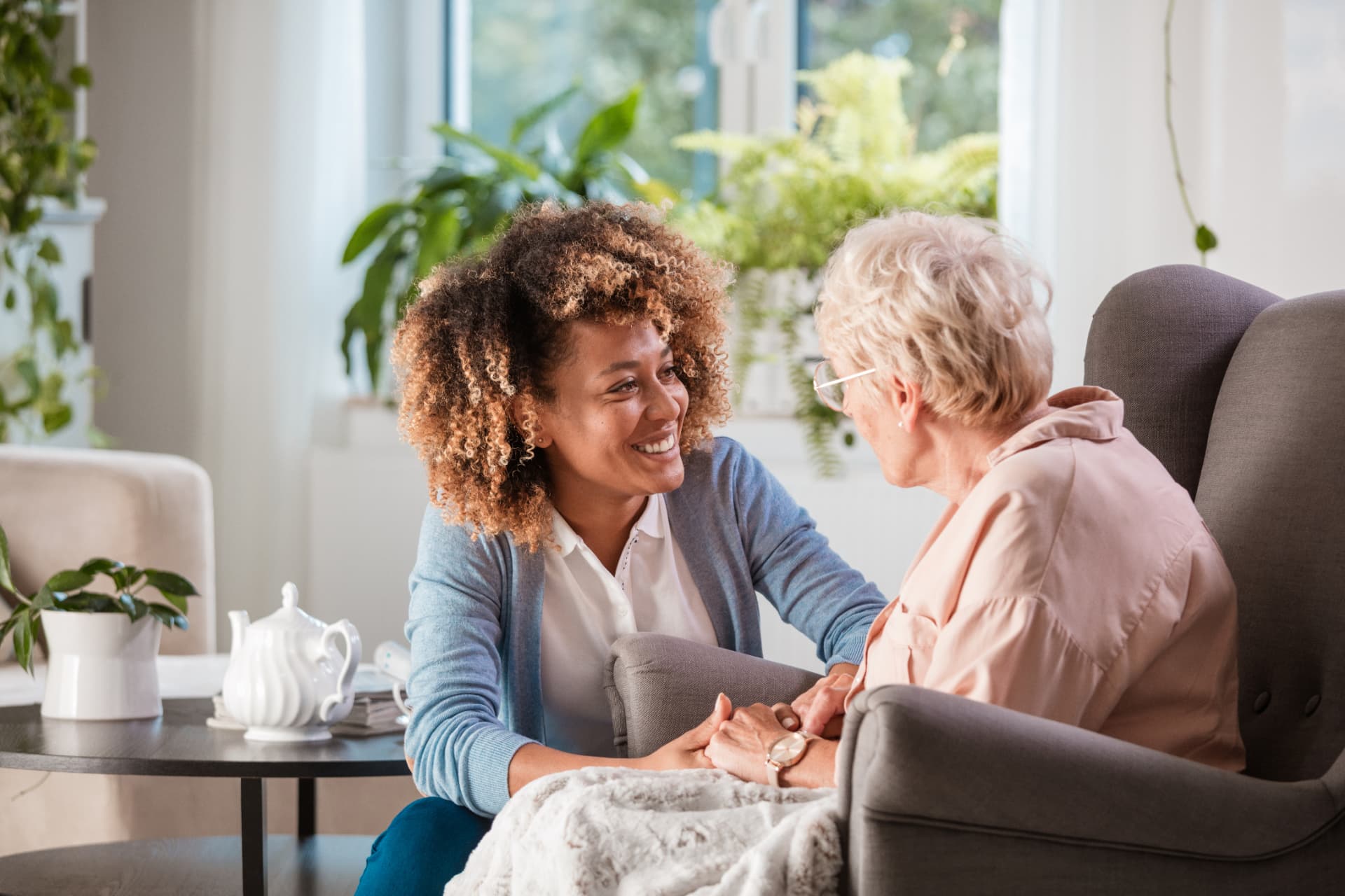 A therapist and older adult talking together in a comfortable setting